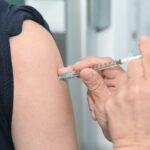 A person getting an injection in the arm.