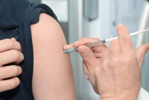 A person getting an injection in the arm.