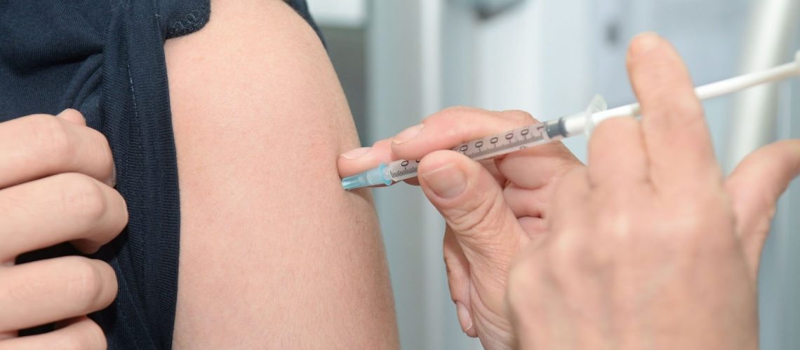 A person getting an injection in the arm.