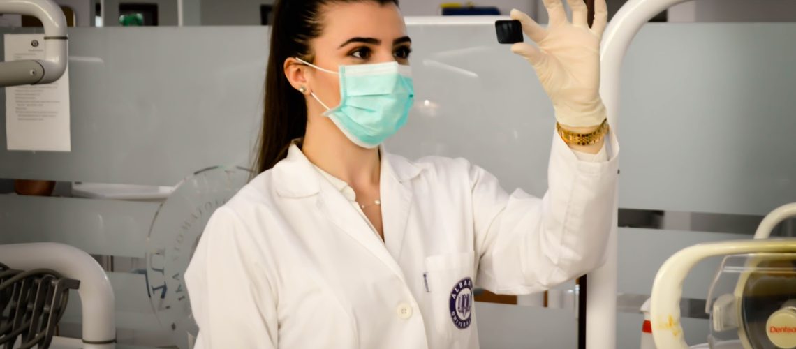 nurse with mask looking at sample OSHA